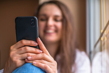 video communication concept. the girl communicates with positive emotions through a smartphone video call.