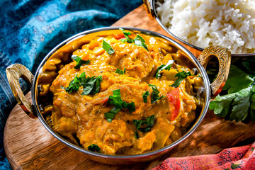 Curry chicken with rice served in original indian karahi pots
