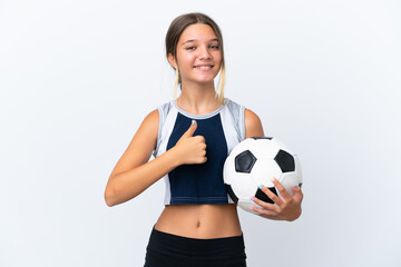 Little caucasian girl playing football isolated on white background giving a thumbs up gesture