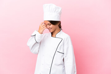 Little caucasian chef girl isolated on pink background laughing