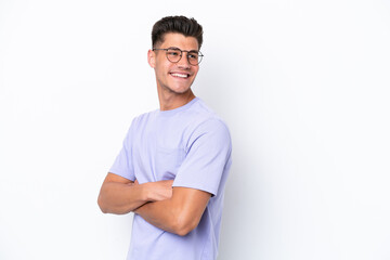 Young caucasian man isolated on white background with arms crossed and happy