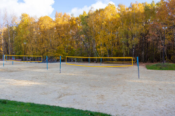 An empty volleyball court on the sand. End of the season. Net for volleyball.