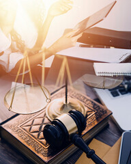 Business and lawyers discussing contract papers with brass scale on desk in office. Law, legal services, advice, justice and law concept picture with film grain effect