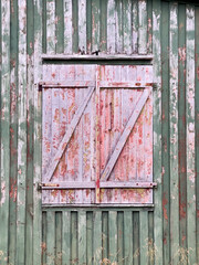 Red vintage window on old barn, Senja island, Norway
