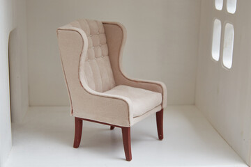 Armchair for a doll in a doll house. Miniature and roombox hobby.