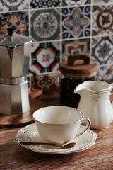 Coffee cup mockup and kitchen utensils table Portuguese and Spain Azulejo tile background,trendy Eco style home still life. Space for text or menu . Business food brand template. 