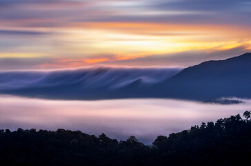 Aerial view Beautiful  panorama of morning scenery Golden light sunrise And the mist flows on high mountains forest. Pang Puai, Mae Moh, Lampang, Thailand.