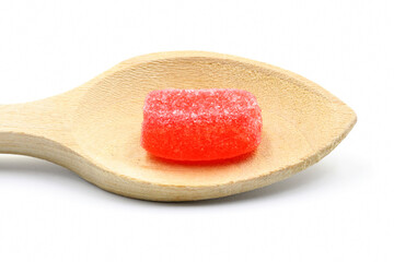 Strawberry jelly beans on a wooden spoon