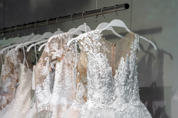 Beautiful bridal dress on hangers. Wedding dress close up at the wedding salon. Wedding dresses...