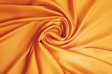 Delicate orange silk fabric as background, top view