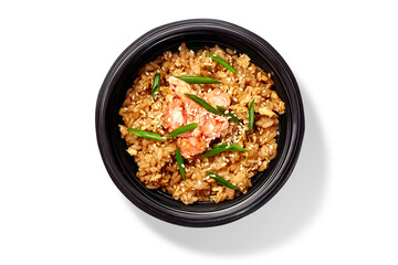Spicy chahan fried rice dish with shrimps, sesame and green onion in black bowl on white
