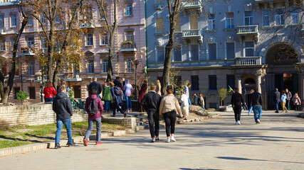 Kyiv, Ukraine - October 16, 2022: People near the funnel from the explosion of a Russian rocket on a children's playground in the center of the capital.