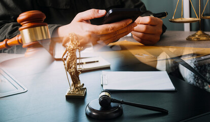 Business and lawyers discussing contract papers with brass scale on desk in office. Law, legal services, advice, justice and law concept picture with film grain effect