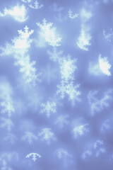 Bokeh as lights white snowflakes on blue background, abstract winter holiday wallpaper with optical blurred pattern. Christmas or New Year abstract image as backdrop, aesthetic blur