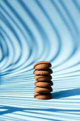 Sweet homemade brown cookies on blue background. Biscuit,  pastry. Top view, copy space, mockup. Flat lay. Food and drink.