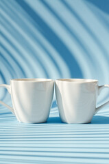 Cups of hot black coffee, tea on blue background. Top view, copy space, mockup. Flat lay. Modern breakfast food.