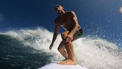 Surfer riding tropical blue ocean wave surfing