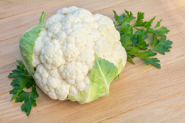 A head of cauliflower on a wooden background