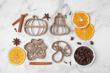 Flat lay composition with cookie cutters and spices on white marble table