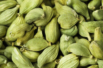 Dry green cardamom pods as background, closeup