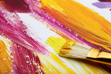 Painting with colorful oil paints on white canvas, closeup view