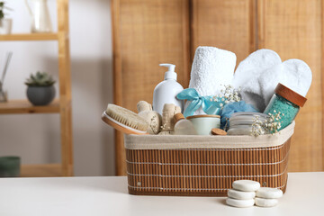 Spa gift set with different products on white table in bathroom. Space for text