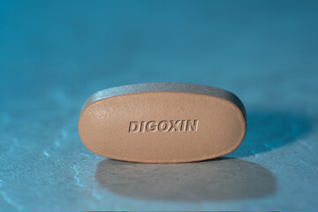 Digoxin drug Pill Medication ob blue background