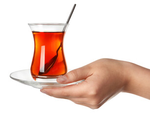 Woman holding glass of Turkish tea on white background, closeup