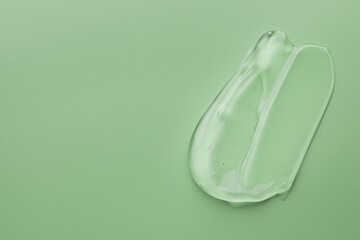 Sample of gel on green background, top view. Space for text