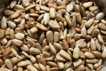 Pile of peeled sunflower seeds as background, closeup
