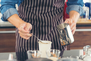 Close up hands coffee barista man make hot cup espresso shot from coffee machine. Cappuccino with milk in italian coffee shop cafe. Close up hands of barista use machine make black drinking hot cup