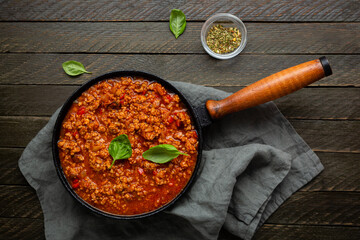 Overhead view of red meat sauce in skillet pan on textile rustic - 540445386