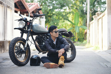 Asian man motorbike in black leather jacket travel rider trip. Handsome Men wear sunglass outdoor...