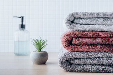 Obraz na płótnie Canvas Towels. Clean fresh fluffy towels and bath accessories on table in bathroom