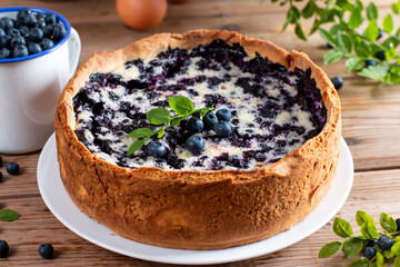 Blueberry pie with cottage cheese on wooden table