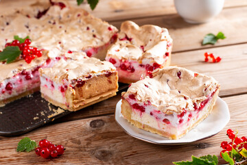 Redcurrant cheesecake, tart with fresh berries on wooden table