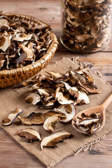 Arrangement of Forest Dried Mushrooms on Wooden table. Focus on Foreground