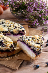 Piece of homemade blueberry cake with berries on wooden table , close up