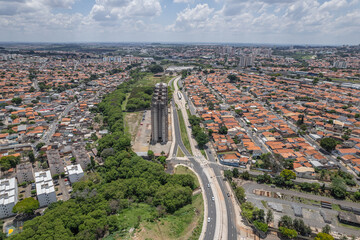 Abandoned buildings in the city of Campinas, countryside of S&atilde;o Paulo. Vegetation, construction debris and vehicles circulating around the residential neighborhood.