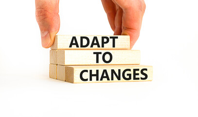 Adapt to changes symbol. Concept words Adapt to changes on wooden blocks. Businessman hand....