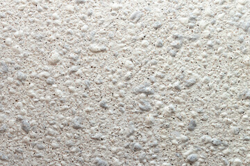 Fragment of a wall covered with decorative plaster 
