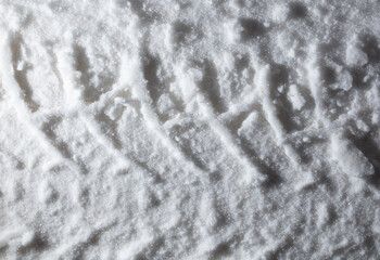 Traces from a car in winter as a background.