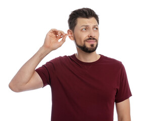 Fototapeta premium Emotional man cleaning ears on white background