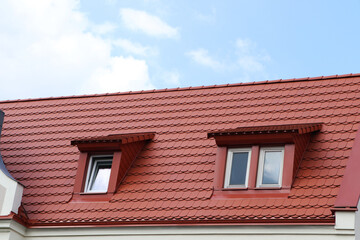 View of beautiful house with brown roof against cloudy sky