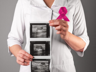 Breast ultrasound result, scan in doctor hand. Checkup for October awareness day