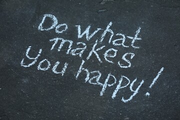 Phrase Do What Makes You Happy with exclamation mark written on asphalt