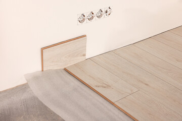 Parquet plank near wall in room prepared for renovation