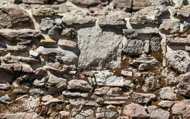 Ancient brick wall made of stone as an abstract background.