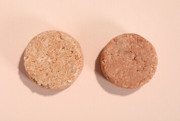 Solid shampoo bars on pink background, flat lay. Hair care