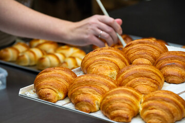 hand holding croissant Cas Wolters